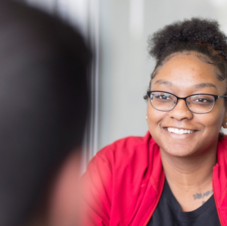 a smiling patient in a red shirt