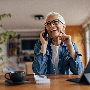 Patient holding clear aligner in treatment chair