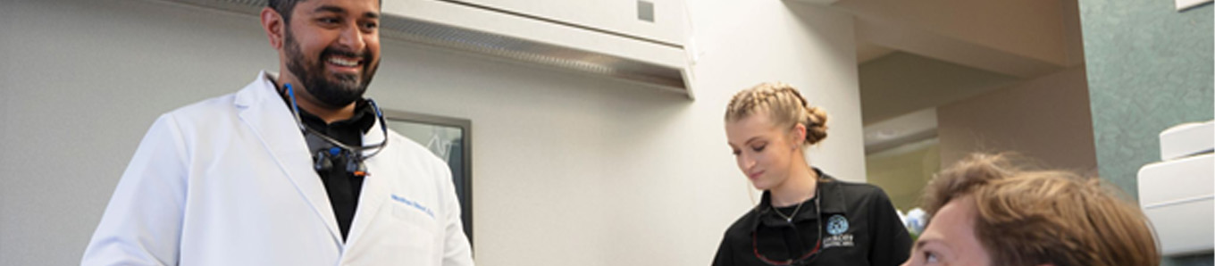 Dr. Shroff talking to patient about gum disease treatment in Centennial