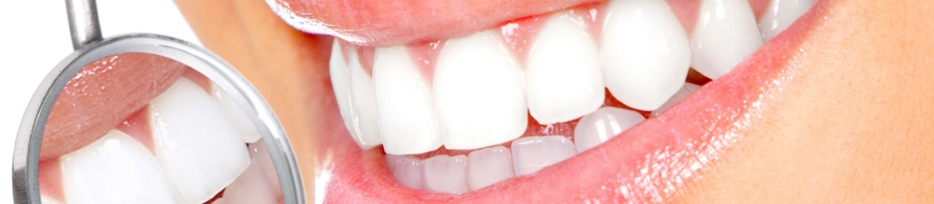 Examining teeth with dental mirror after teeth whitening in Centennial